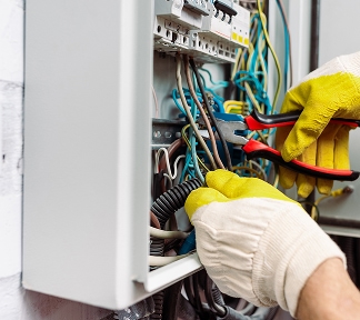 Electrician carrying out fault finding in a local property