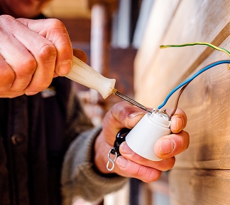 Electrician carrying out fault finding in a local property